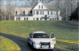  ?? JASON DECROW/AP 2012 ?? A police cruiser sits in the driveway of the home Adam Lanza’s mother in Newtown.