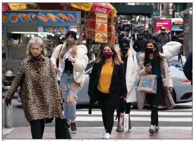  ?? (AP/Mark Lennihan) ?? Women carry shopping bags in New York on Dec. 10. Retail sales increased 3% during the holiday season this year, the National Retail Federation said.