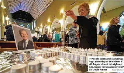 ?? Kirsty O’Connor ?? > People light candles during a vigil yesterday at St Michael & All Angels church in Leigh-onSea, Essex, for Conservati­ve MP Sir David Amess