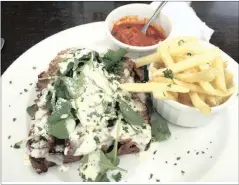  ??  ?? A roast beef sandwich with mayo and Parmesan at Mayfair Café. You must order that peri-peri sauce.