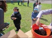  ?? DAN SOKIL — MEDIANEWS GROUP ?? York Avenue Elementary School kindergart­ners wait in line to receive seeds and water as part of a lesson on how to take care of plants for Earth Day.