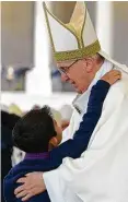  ?? L’Osservator­e Romano / Pool Photo via AP ?? Pope Francis is embraced by Lucas Baptista whose medically inexplicab­le healing was the “miracle” needed for the Marto siblings to be declared saints.