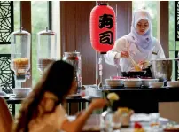  ?? Reuters ?? A Muslim employee cooks as a visitor has breakfast at the Al Meroz hotel in Bangkok, Thailand. —