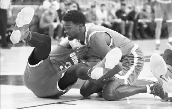  ?? JOHN LOCHER/THE ASSOCIATED PRESS ?? Ohio State’s Trevor Thompson, left, and UCLA’s Isaac Hamilton fight for the ball during the Bruins’ 86-73 victory Saturday at T-Mobile Arena.