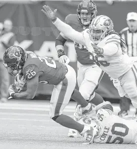  ?? Brett Coomer / Houston Chronicle ?? Texans running back Lamar Miller, left, is tripped up by 49ers linebacker Brock Coyle during Sunday’s loss at NRG Stadium, a play symbolic of Miller’s rough 2017 campaign. The running back is averaging just 3.6 yards per carry.