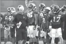  ?? JASON GETZ / The Associated Press ?? Atlanta coach Mike Smith walks the sidelines during a recent scrimmage for the Falcons.