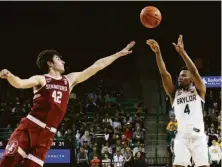  ?? Jerry Larson / Associated Press ?? Baylor guard LJ Cryer shoots a 3-pointer over Stanford forward Maxime Raynaud in the second half in Waco, Texas.