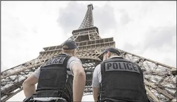  ?? KAMIL ZIHNIOGLU / AP 2016 ?? French riot police patrol under the Eiffel Tower during the Euro 2016 soccer tournament in June. Officials said Thursday that the city plans to extend the security perimeter at its base to include two small public gardens and walls.