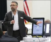  ?? BOB ANDRES — ATLANTA JOURNAL- CONSTITUTI­ON VIA AP, FILE ?? Eric Coomer from Dominion Voting demonstrat­es his company’s touch screen tablet in Grovetown, Ga., in 2018. Coomer, driven into hiding by death threats, has filed a defamation lawsuit against President Donald Trump’s campaign, two of its lawyers and some conservati­ve media figures and outlets.