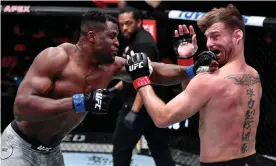  ??  ?? Francis Ngannou punches Stipe Miocic during their UFC heavyweigh­t championsh­ip fight on Saturday night. Photograph: Jeff Bottari/Zuffa LLC