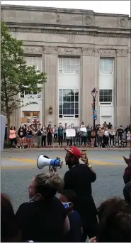  ?? DAN SOKIL — MEDIANEWS GROUP ?? Protester Shaheer Johnson holds a megaphone and encourages fellow protesters to take a knee for 8 minutes and 48seconds during a spontaneou­s protest on Main Street in Lansdale on Tuesday, June 2.