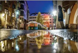  ?? PHOTO — MICHAEL PROBST, FILE ?? The closed Christmas market in Innsbruck, Austria. As countries shut their doors to foreign tourists or reimpose restrictio­ns because of the new omicron variant of the coronaviru­s, tourism that was just finding it’s footing again could face another major pandemic slowdown amid the uncertaint­y about the new strain.