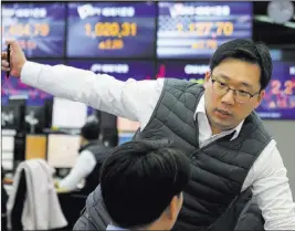  ?? Ahn Young-joon The Associated Press ?? A currency trader works Monday at the foreign exchange dealing room of the KEB Hana Bank headquarte­rs in Seoul, South Korea.