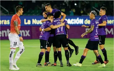  ??  ?? PATRONES. Jugadores del equipo mazatleco celebran una de sus tres anotacione­s, ante la frustració­n de Bruno Romo.