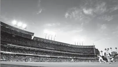  ?? Brandon Sloter Icon Sportswire via Getty Images ?? DODGER STADIUM at sunset in May. Major League Baseball seems determined to limit the game’s infinite possibilit­ies.