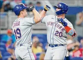  ?? Lynne Sladky / Associated Press ?? Pete Alonso, right, of the Mets is met by Mark Canha after hitting a solo home run in the second inning against Miami, his first of two on the day.