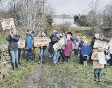  ?? ?? PROTEST: Campaigner­s at Greetland protest against proposals in the draft Local Plan after flooding