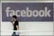  ?? THE ASSOCIATED PRESS ?? A Facebook employee walks past a sign at the Facebook headquarte­rs in Menlo Park, Calif.