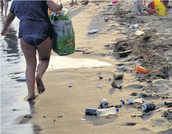  ??  ?? > After the hottest day of the year, Barry Island beach was left covered in rubbish, arguable a tangible example of our society not functionin­g properly