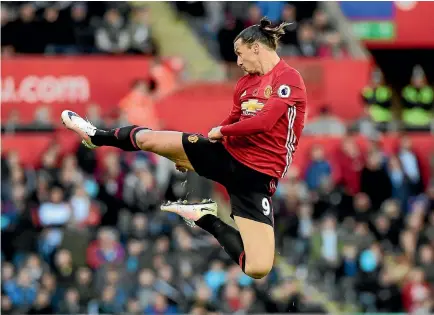  ?? PHOTO: REUTERS ?? Manchester United’s Zlatan Ibrahimovi­c celebrates after scoring one of his two goals in the 3-1 win over Swansea City yesterday.