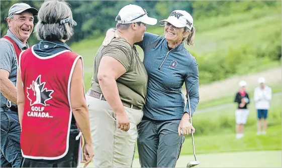 ?? BOB TYMCZYSZYN THE ST. CATHARINES STANDARD ?? Sue Wooster of Australia, right, embraces Christina Proteau on the 18th hole at the Canadian Women's Mid-Amateur and Senior Championsh­ip at Lookout Point Country Club in Fonthill.