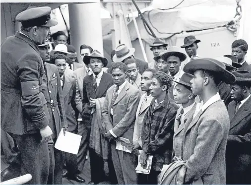  ??  ?? NEW WORLD: Jamaican immigrants being welcomed by RAF officials after the ex-troopship HMT ‘Empire Windrush’ landed them at Tilbury