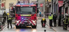  ??  ?? EARLY MORNING HORROR: Firefighte­rs clearing up at the scene of the fire yesterday in the centre of Sligo town