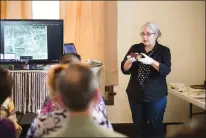  ?? Staff photo by Joshua Boucher ?? Jamie Simmons, Texarkana Museums System curator, shows a daguerreot­ype during a lecture Saturday at the P.J. Ahern Home Museum on how to identify the age of old photograph­s.