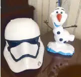  ??  ?? Brought home a Stormtroop­er coin bank and an Olaf tumbler from the Disney souvenir stores all over the park.