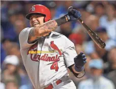  ?? JERRY LAI, USA TODAY SPORTS ?? Cardinals catcher Yadier Molina, grimacing after a swing in Monday’s Game 3, might have aggravated his thumb injury.