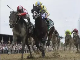  ?? TONI L. SANDYS, THE WASHINGTON POST ?? Jockey Javier Castellano riding Cloud Computing, in red and white, just beats Classic Empire, ridden by Julien Leparoux, to a first-place finish in the 142nd running of the Preakness Stakes.