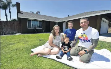  ?? WILL LESTER — STAFF PHOTOGRAPH­ER ?? Daniel and Rio Baeza relax outside their Ontario home with their children, Logen, 14, and Collin, 18 months, on June 4. The family, who had been renting a condo, decided to join the bidding wars taking place in the region’s housing market.