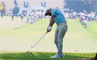  ?? CHARLIE RIEDEL/ASSOCIATED PRESS ?? Dustin Johnson, who won last year’s Masters at 20-under when it was played in November, hits on the first fairway at Augusta National on Wednesday in a practice round.