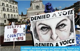  ??  ?? FLORENCE: Anti-Brexit protesters hold placards reading ‘Europe is my country - make it (y)ours again’ (L) and ‘Denied a Vote - Denied a Voice’ on September 22, 2017. — AFP