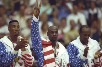  ?? MIKE POWELL/STAR WIRES FILE PHOTO ?? From left, Scottie Pippen, Michael Jordan and Clyde Drexler celebrate their 1992 gold medal in Barcelona.