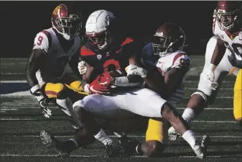  ?? ASSOCIATED PRESS ?? SOUTHERN CALIFORNIA LINEBACKER DRAKE JACKSON (99) tackles Arizona running back Gary Brightwell (0) in the second half during a game on Saturday in Tucson.