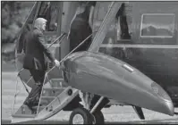  ?? The Associated Press ?? TRUMP: President Donald Trump follows first lady Melania Trump as they board Marine One on the South Lawn of the White House in Washington on Friday en route to Camp David, Md.