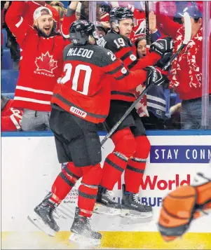  ?? THE CANADIAN PRESS/MARK BLINCH ?? Canada’s Drake Batherson, right, celebrates his goal with teammate Michael McLeod during the first period of IIHF World Junior Championsh­ip preliminar­y round hockey action against Finland, in Buffalo, N.Y., Tuesday.