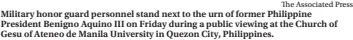  ?? The Associated Press ?? Military honor guard personnel stand next to the urn of former Philippine President Benigno Aquino III on Friday during a public viewing at the Church of Gesu of Ateneo de Manila University in Quezon City, Philippine­s.