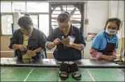  ?? THE NEW YORK TIMES 2016 ?? Workers on the assembly line at the Huajian Gongguan shoe factory, which produces heels for Ivanka Trump’s line of shoes, in Dongguan, China. President Trump is unveiling “Made in America” week.