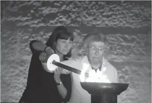  ?? (Marc Israel Sellem/The Jerusalem Post) ?? SURVIVOR OLGA KAY, accompanie­d by her daughter, lights one of the six beacons at the Holocaust Martyrs’ and Heroes’ Remembranc­e Day opening ceremony at Yad Vashem yesterday.