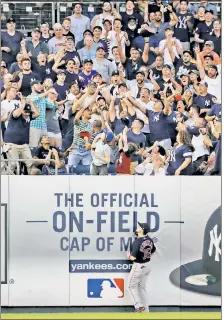  ?? Paul J. Bereswill ?? OUTTA MY WAY! Yankees fans battle for a souvenir following Miguel Andujar’s fourth-inning homer.