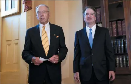  ?? SUSAN WALSH — THE ASSOCIATED PRESS ?? Supreme Court nominee Brett Kavanaugh, right, listens as Sen. Chuck Grassley, R-Iowa, left, speaks Tuesday on Capitol Hill in Washington.