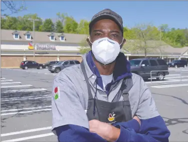  ?? H John Voorhees III / Hearst Connecticu­t Media ?? Brian Simmons, who works at the Newtown Stop & Shop, is one of the many grocery workers in the state who have continued to go to work amid a pandemic, despite risks to their health.