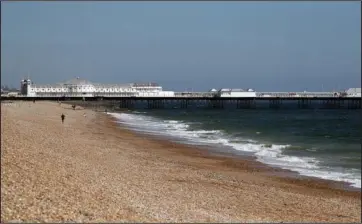  ?? The Associated Press ?? DESERTED: A view of a virtually empty beach in Brighton, England, on April 25 as the UK continues its lockdown to help curb the spread of coronaviru­s.