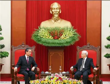  ??  ?? Friends: Wang (left) speaking with Vietnam’s Communist Party General Secretary Nguyen Phu Trong at the party’s head office in Hanoi. — Reuters