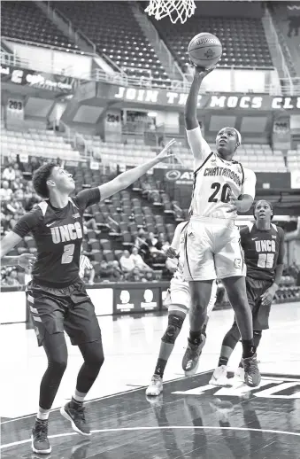  ?? STAFF PHOTO BY ROBIN RUDD ?? UTC’s Keiana Gilbert shoots during Thursday’s Southern Conference opener against UNC Greensboro at McKenzie Arena. Gilbert scored 14 points and grabbed eight rebounds to lead the Mocs to a 49-42 win.