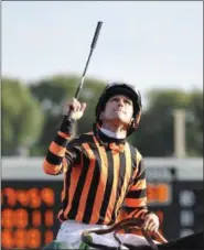 ?? JIM PRISCHING — THE ASSOCIATED PRESS FILE ?? Jockey, Ramon A. Dominguez, celebrates aboard Little Mike after winning the Arlington Million horse race at Arlington Park Aug. 18, 2012in Arlington Heights, Ill.