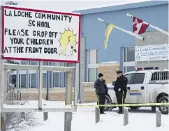  ?? JONATHAN HAYWARD / THE CANADIAN PRESS FILES ?? Members of the RCMP stand outside the La Loche Community School in La Loche, Sask.