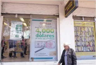  ?? REBECCA BLACKWELL/THE ASSOCIATED PRESS ?? A Mexico City business advertises money transfer services, which Donald Trump proposes to curtail. The theory is that the lost income would force Mexico to pay for a border wall.
